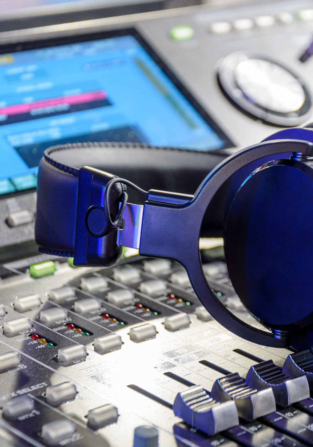 Studio headphones lying on the audio mixer. Live and studio equipment.